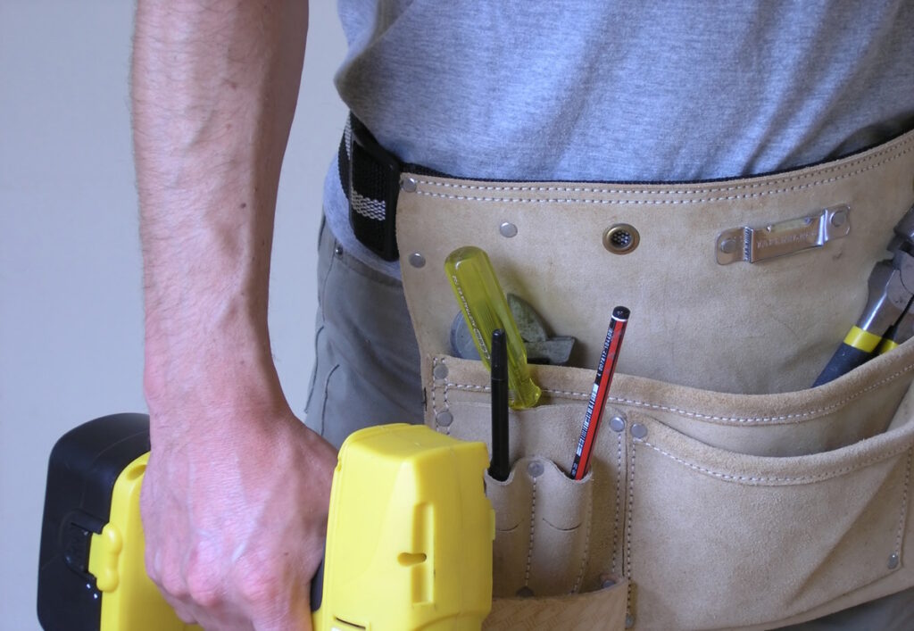 A man, who is a contractor, is standing with his tool belt and drill - CK Contracting, Custom Home Renovations, Mount Pleasant, SC