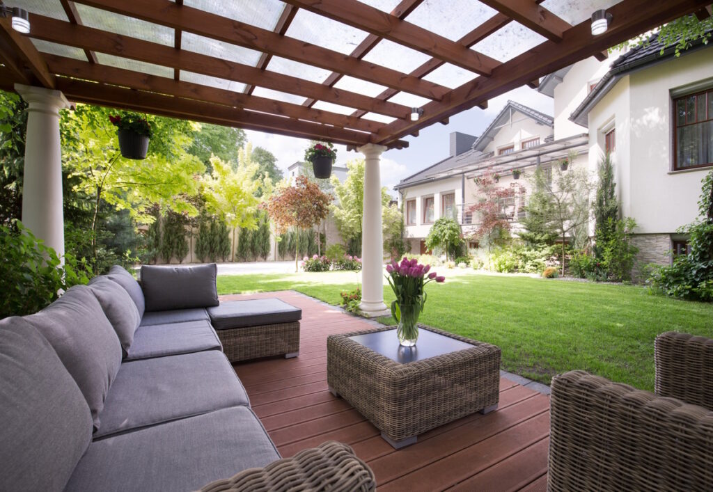 Outdoor Patio Area which includes wooden floor and a Lattice Roof with clear window ceiling and four columns. CK Contracting, Outdoor Living Space, Mount Pleasant General Contractor, Mount Pleasant, S.C.